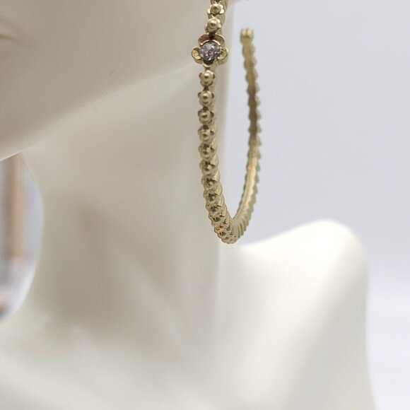 Gold Tone Textured Hoop Earrings With Rhinestone Flower Accents - Picture 3 of 7